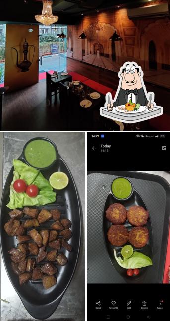 Take a look at the photo showing food and interior at Qabeela