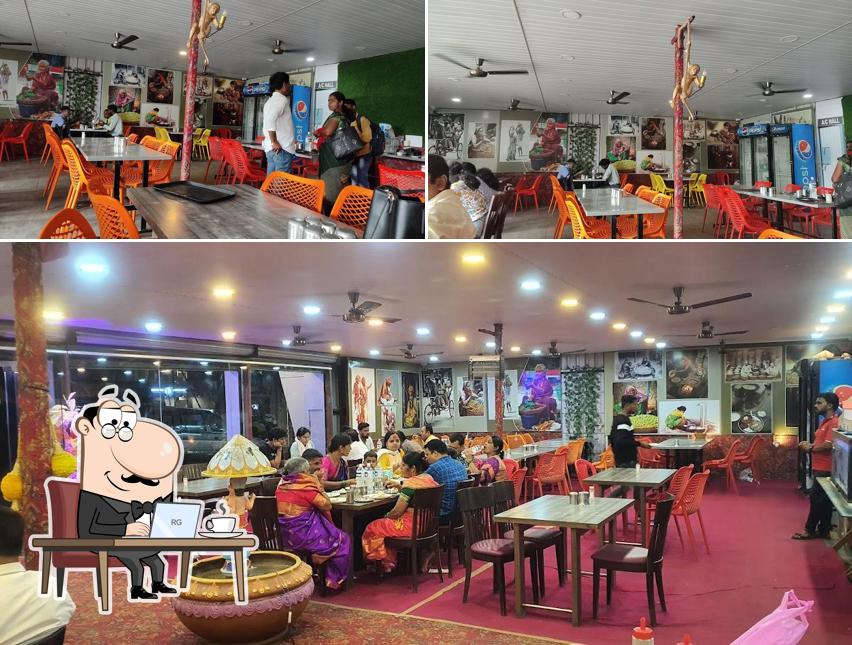Take a seat at one of the tables at HOTEL SAMADHAN FAMILY RESTAURANT PURE VEG