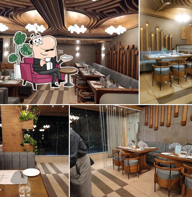 Take a seat at one of the tables at Flavour Dine Restaurant And Banquet (pure veg)
