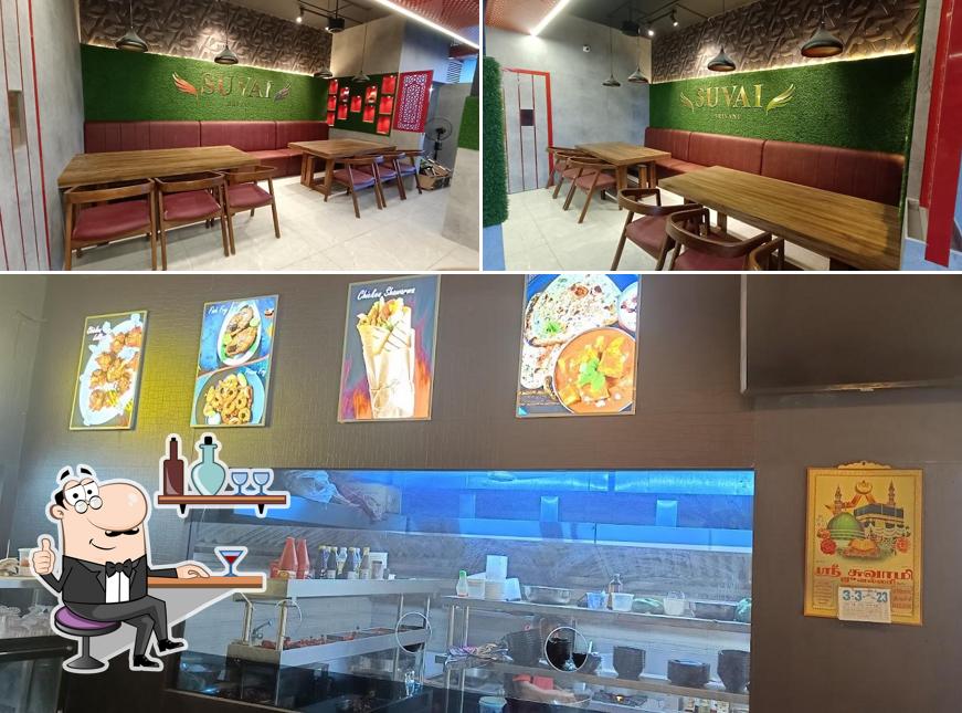 Take a seat at one of the tables at SUVAI BIRIYANI CENTER