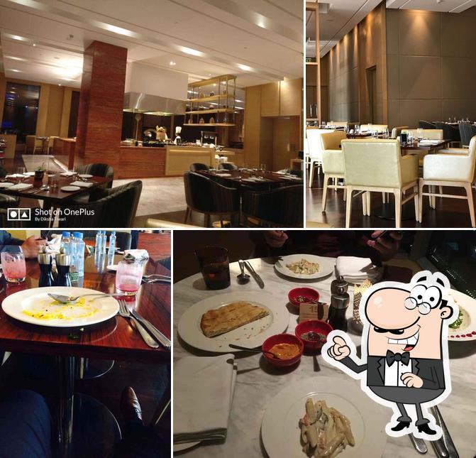 Take a seat at one of the tables at Rocca - Hyatt Regency Lucknow