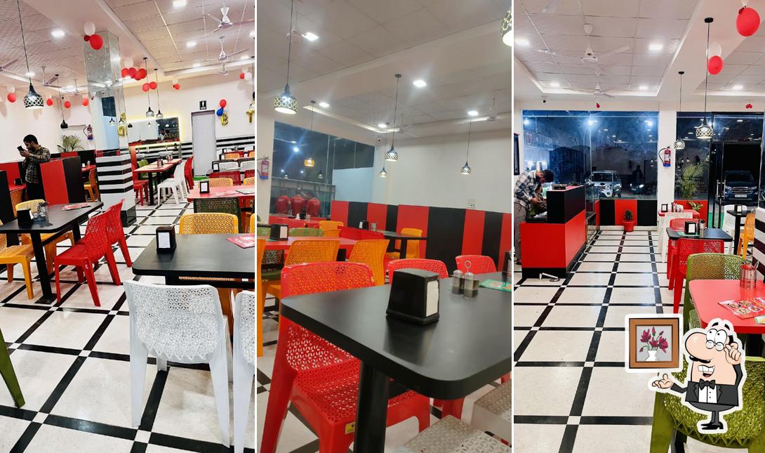 Take a seat at one of the tables at PRINCE RESTAURANT AND HOTELS