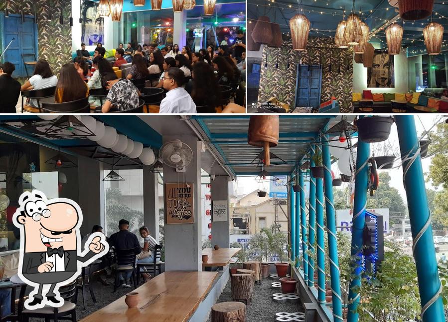 Take a seat at one of the tables at TIMES CAFE SAYAJIGUNJ