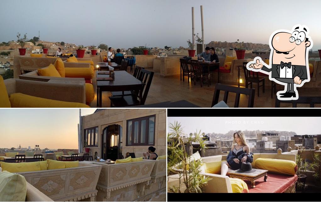 Take a seat at one of the tables at Pleasant Haveli - Rooftop Restaurant & AC DINNING