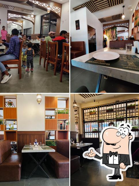 Take a seat at one of the tables at PLANET Multi Cuisine Restaurant