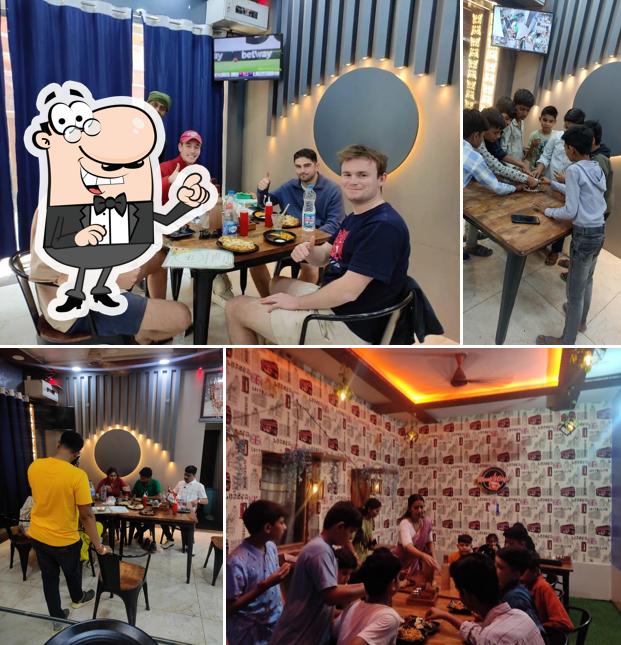 Take a seat at one of the tables at manali sweet & cafe