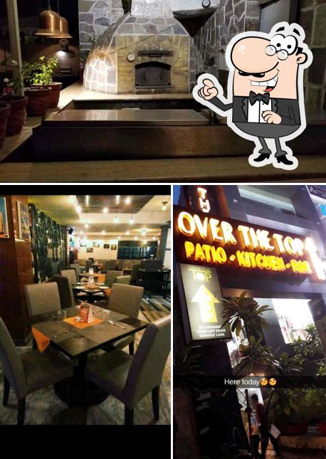 Take a seat at one of the tables at Over The Top Restaurant & BAR- Janakpuri