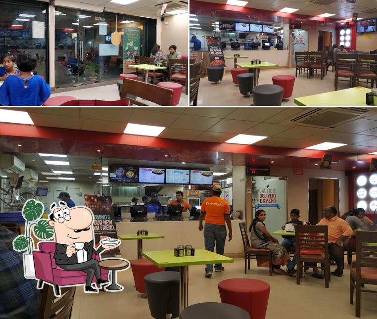 Take a seat at one of the tables at Domino's Pizza Akaram Village, Musheerabad