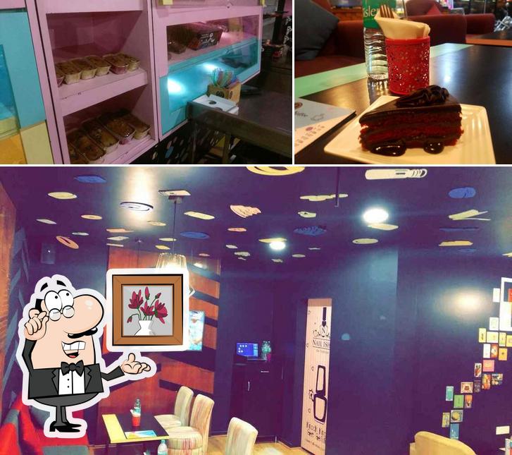 Take a look at the image displaying interior and dining table at Ghrelin Cafe and Patisserie - Banjara Hills