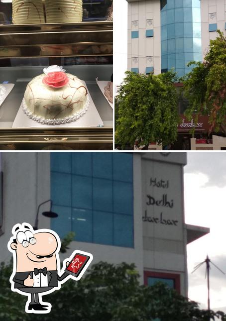 This is the picture displaying exterior and cake at Hotel Delhi Darbar
