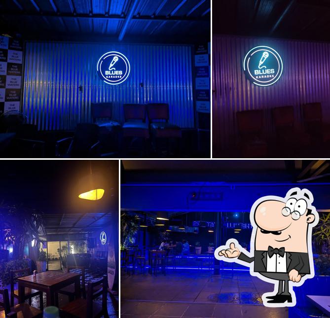 Take a seat at one of the tables at Blue Waters Bar And Restaurant