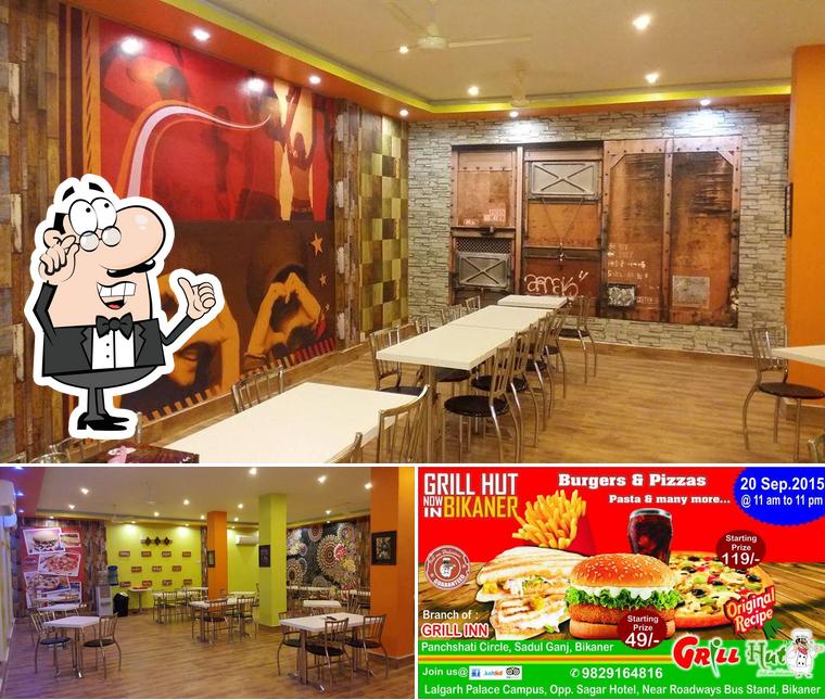 This is the photo showing interior and burger at GRILL HUT INDIA