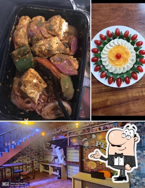 Take a seat at one of the tables at Cafe Mehfil & Resto- Cabin Cafe in Mansarovar