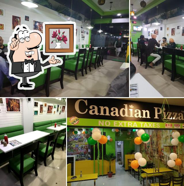Take a seat at one of the tables at Canadian pizza Hot & Fresh We Are Back