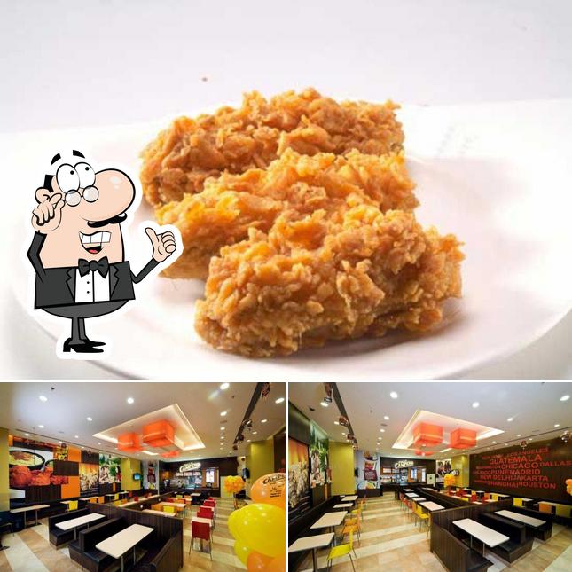 Check out the image displaying interior and food at Pollo Campero