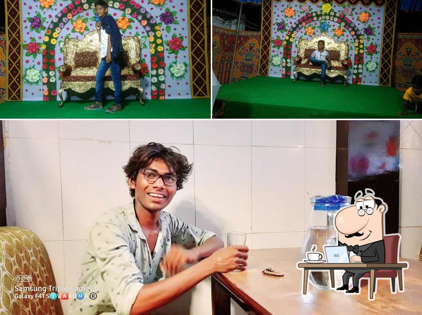 Take a seat at one of the tables at saregama bar& restaurant A/C ,rooms ,garden up
