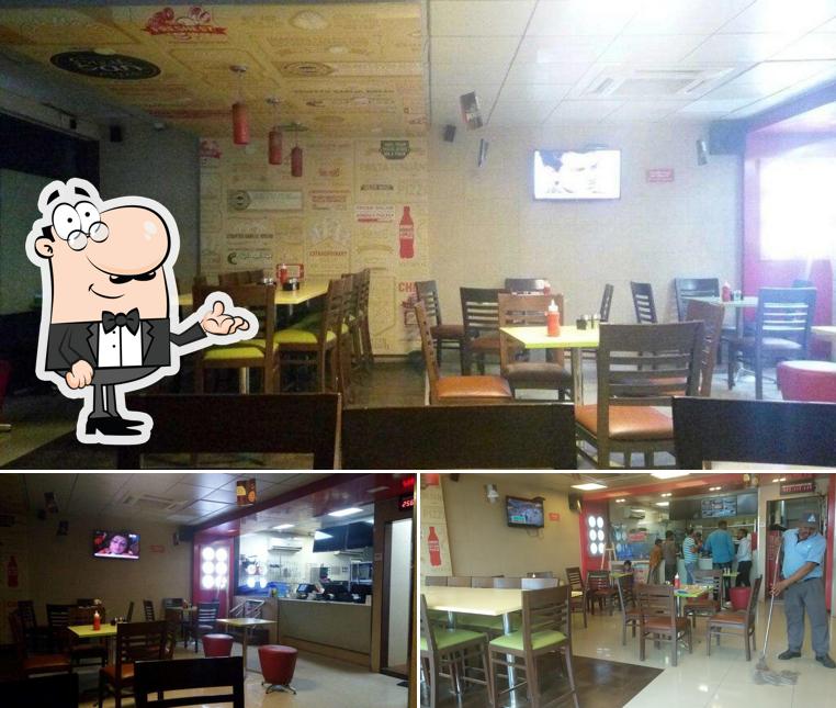 Take a seat at one of the tables at Domino's Pizza Bhosari, Pune