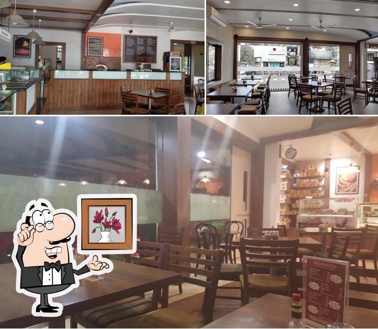 Take a seat at one of the tables at Buns N Coffees - The Cafe Lounge