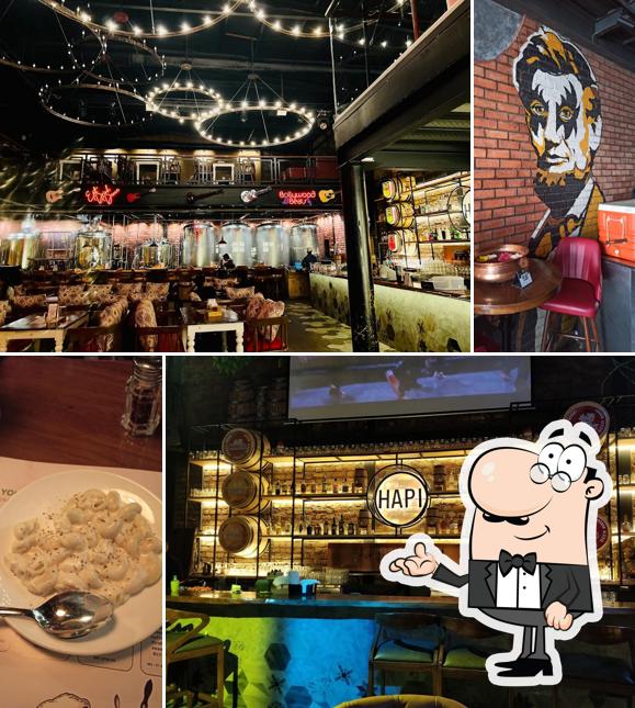 Take a seat at one of the tables at R Hapi Restaurant Mira Road