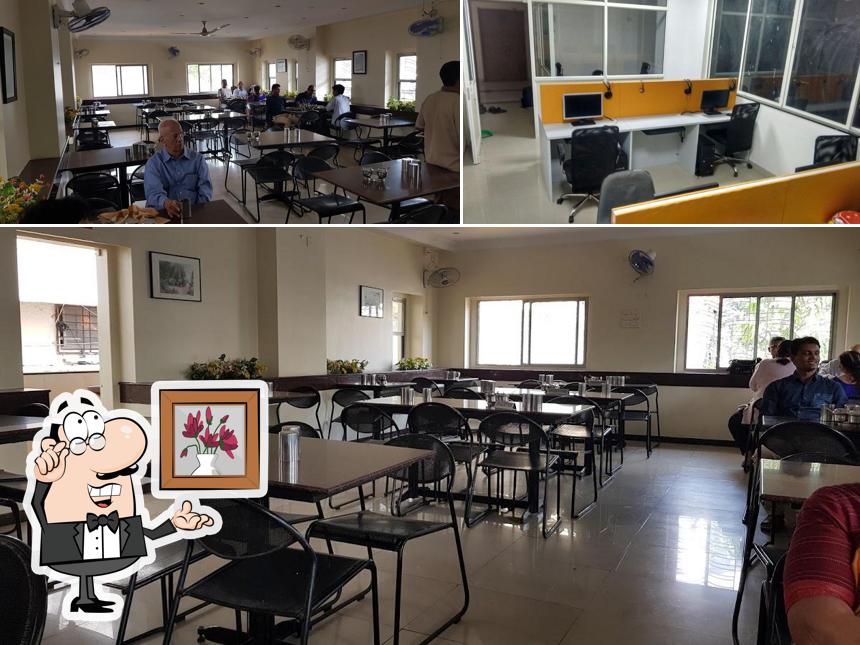 Take a seat at one of the tables at Janaseva Bhojanalaya