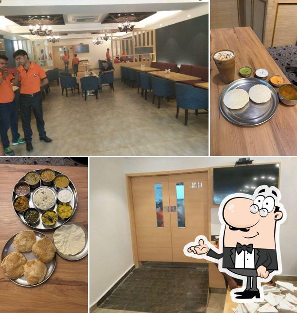 Take a seat at one of the tables at Anna's Dosa - Lulu Mall