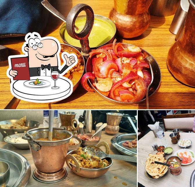 The photo of food and dining table at Sher-e-Punjab Restaurant