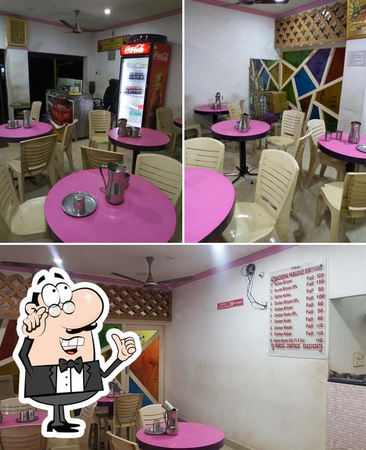 Take a seat at one of the tables at Al-madeena Paradise Biriyani's