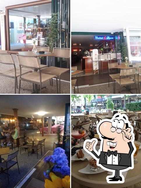 Siediti a un tavolo di American Charlie's Bar