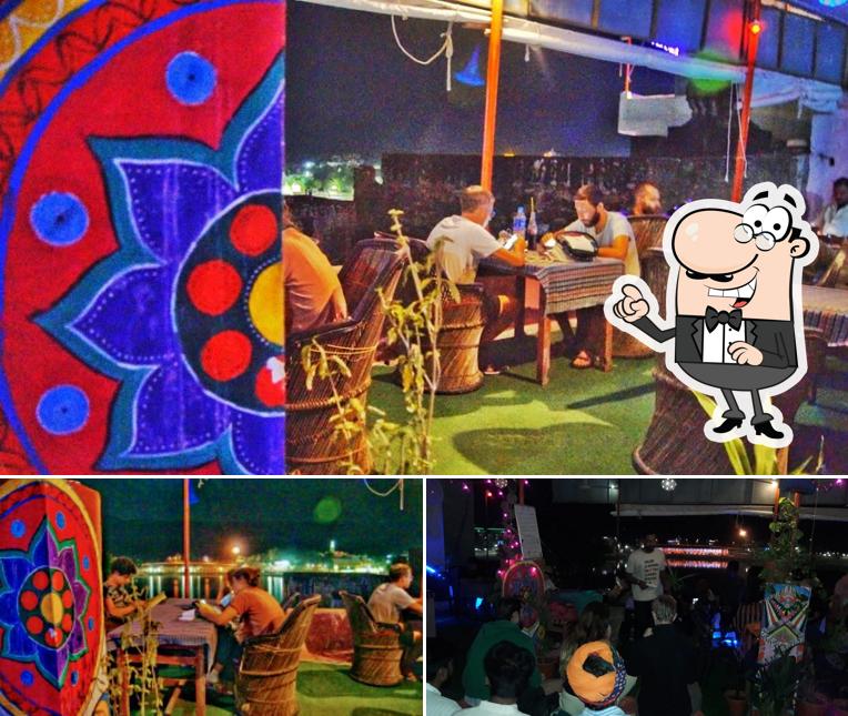 Take a seat at one of the tables at Raju Terrace Garden Restaurent