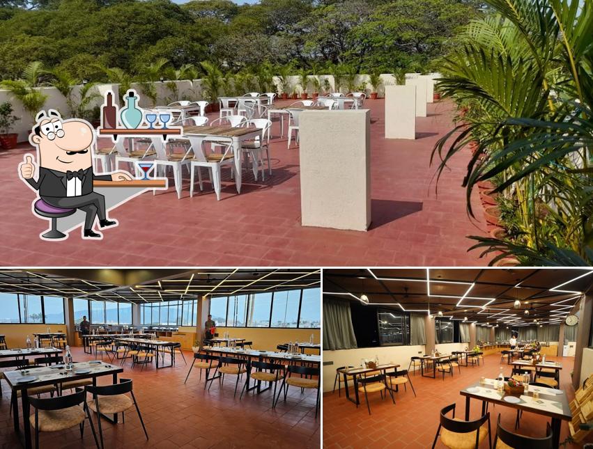 Take a seat at one of the tables at Sattvik - Rooftop Cafe