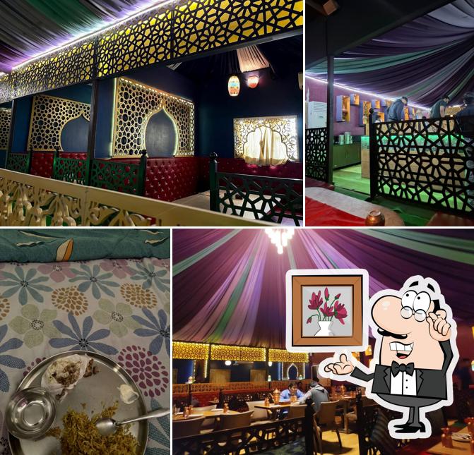 Take a seat at one of the tables at Arabian Mandi- Best family Hyderabadi Restaurant