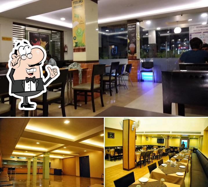 Take a seat at one of the tables at Grand Ashirwad Beacon Hotel, Bhopal