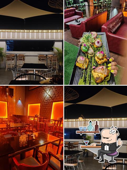 Take a seat at one of the tables at Andromeda Rooftop & Lounge Bar