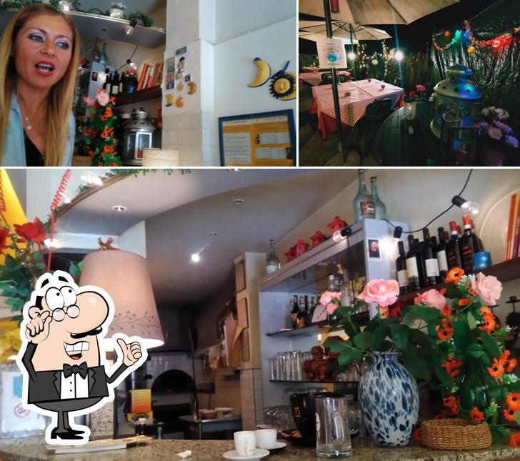 La immagine di interni e tavolo da pranzo da Pizzeria Moonlight