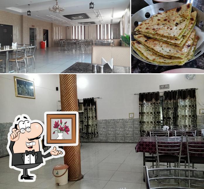 Take a look at the picture displaying interior and pizza at Maharaja Hotel & Restaurant ( PALACE )