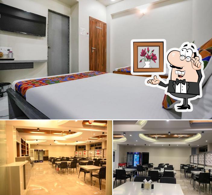 Take a seat at one of the tables at Hotel Priya Lodging