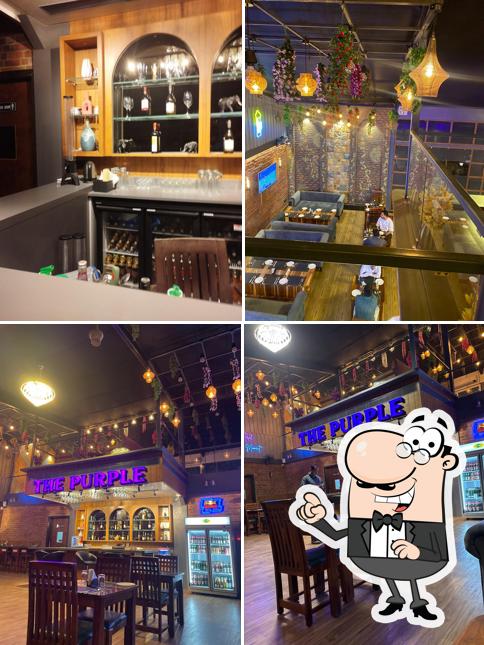 Take a seat at one of the tables at The Purple Lounge Bar & Restaurant