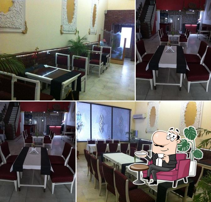 Take a seat at one of the tables at Kwality Restaurant