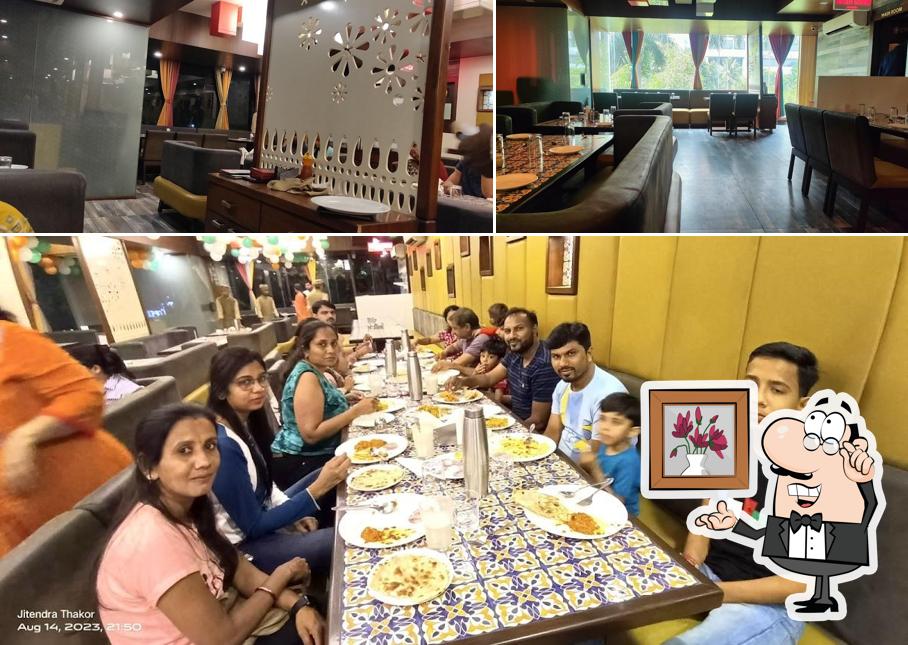 Take a seat at one of the tables at Darshan Restaurant and Banquet