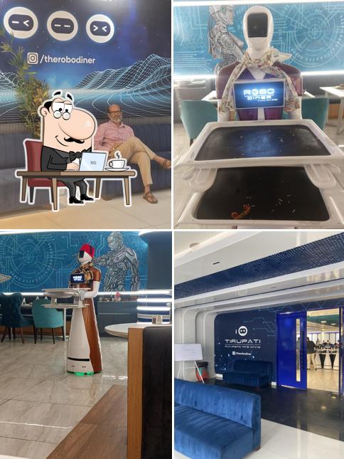 Take a seat at one of the tables at Robo Diner Best Restaurant in Tirupati