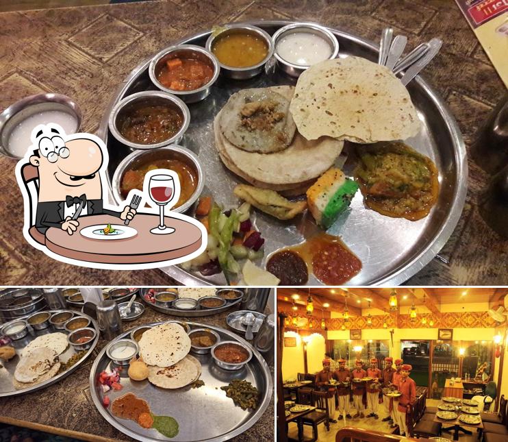 Take a look at the image showing food and dining table at Madhur Bhoj Thali - Best Pure Veg Restaurant In Parbhani Best Thali Restaurant Dal Baati Churma In Parbhani