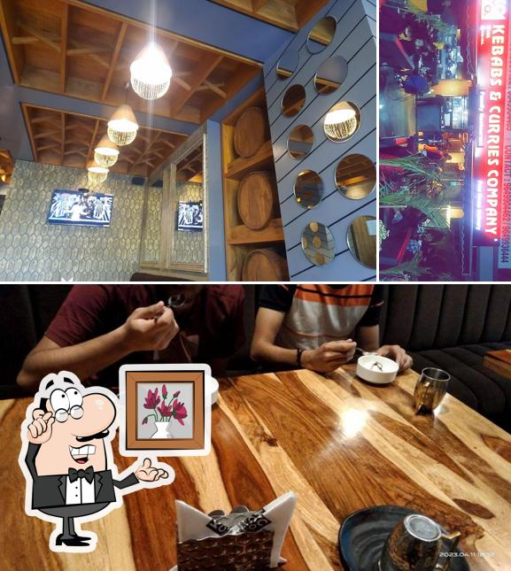 Take a seat at one of the tables at Kebabs & Curries Company - Kota