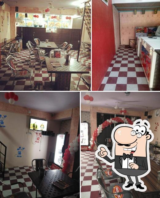 This is the picture displaying interior and dining table at K G N Bakers And Cafe