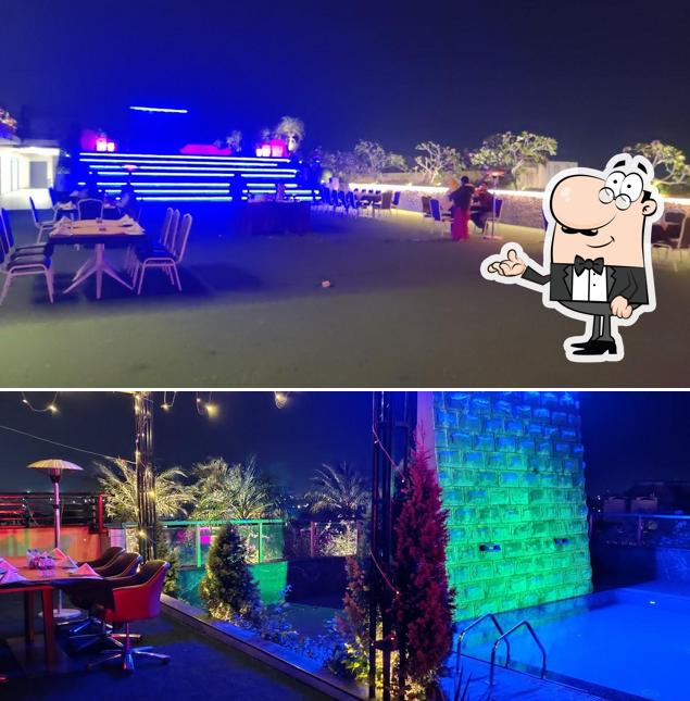 Take a seat at one of the tables at Galaxy Air - Roof Top Lounge