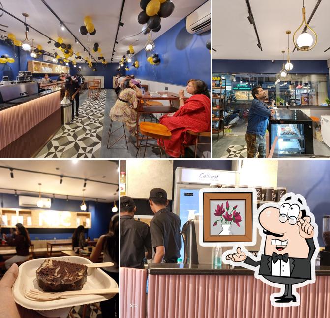 Take a seat at one of the tables at Nothing Before Coffee Cafe - Bhilai