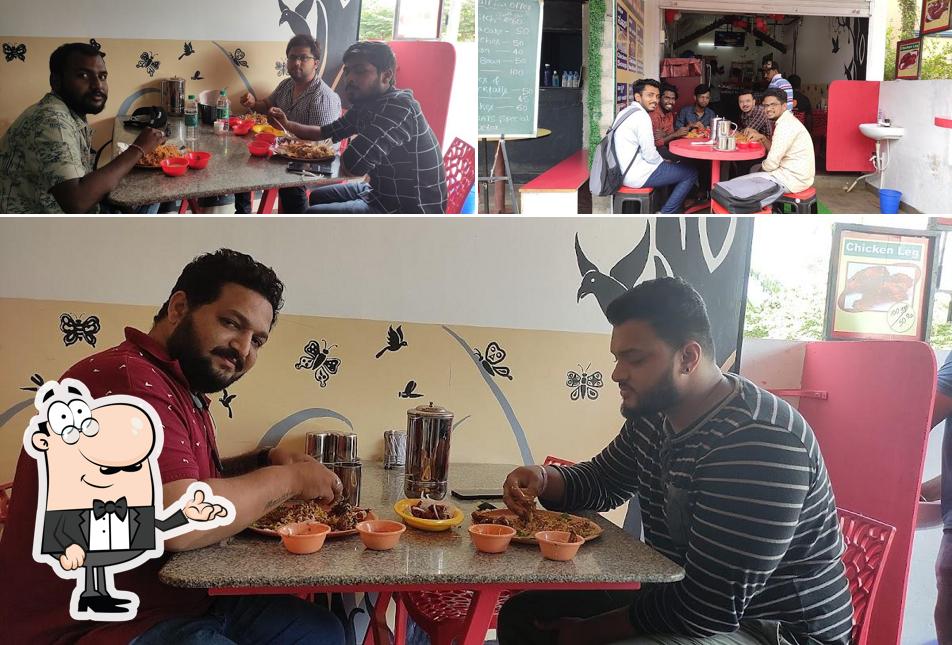 Take a seat at one of the tables at MPR SAVAJI VEG AND NON -VEG MESS & HOTEL