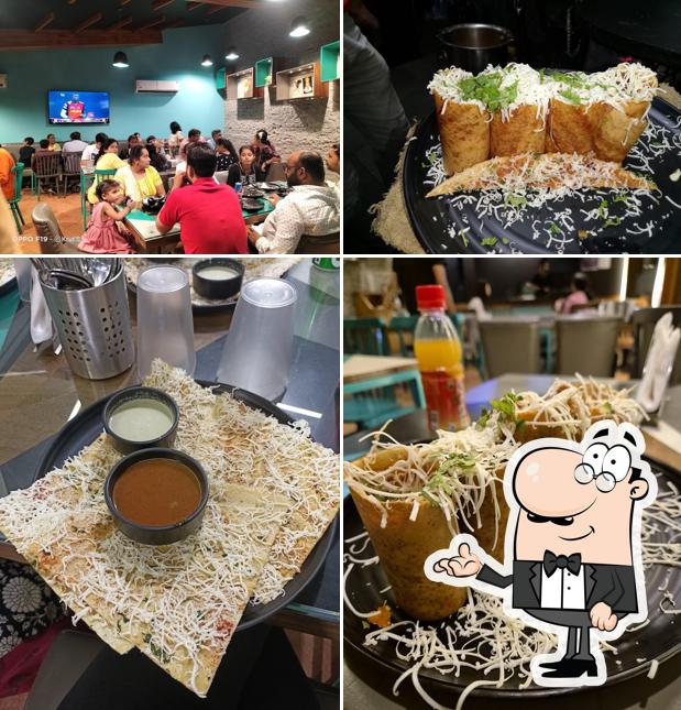 Take a seat at one of the tables at H Dosa Restaurant