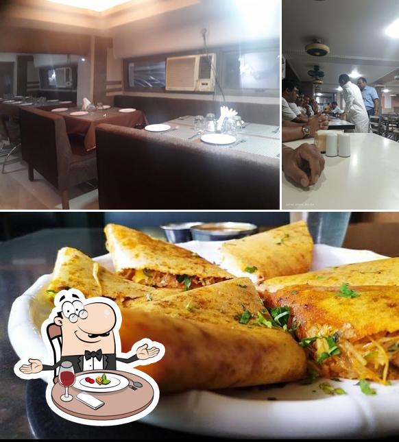 This is the photo depicting dining table and food at Ambika Bhavan Veg Restaurant