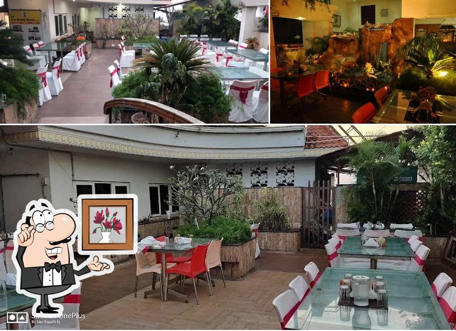 Take a seat at one of the tables at Brindavan Roof Top Restaurant