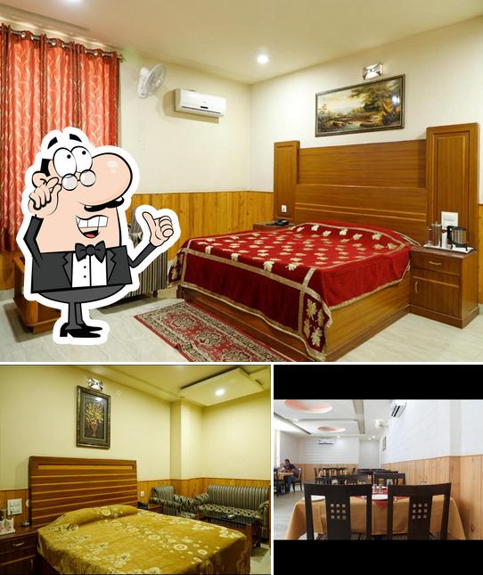 This is the photo showing interior and dining table at Hotel Malabar Bhuntar